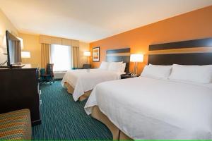 a hotel room with two beds and a flat screen tv at Holiday Inn Bismarck, an IHG Hotel in Bismarck