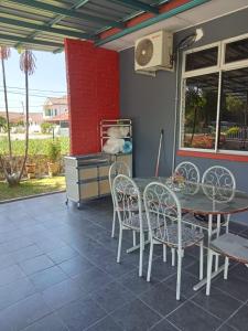 a table and chairs sitting on a patio at Mariah Homestay @ Station 18 in Ipoh