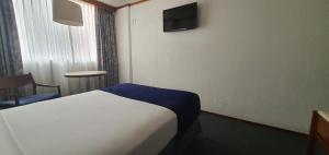 Postel nebo postele na pokoji v ubytování Hotel Bristol