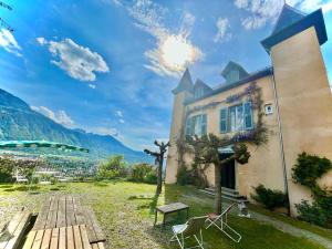 a building with a table and chairs in a yard at Château les Tours 300m², vue panoramique in Ayse