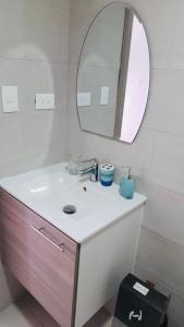 a bathroom with a sink and a mirror at Punta Cana in Punta Cana