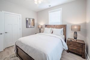 a bedroom with a large white bed and a window at New Construction New Furnishings Luxury Unit in Evansville
