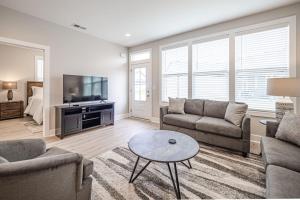 a living room with two couches and a tv at New Construction New Furnishings Luxury Unit in Evansville