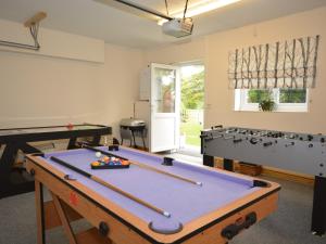 a game room with a pool table and pool balls at 4 Bed in Bideford NILGA in Bideford