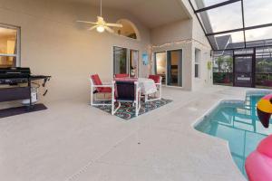 a living room with a pool and a table and chairs at Florida Pool House in Davenport