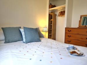 a bedroom with a bed with a tray of food on it at 2 bed property in Galmpton BX008 in Galmpton-on-the-Dart