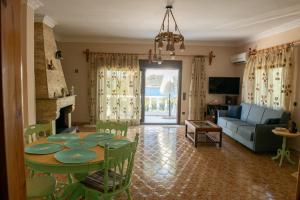 a living room with a table and a couch at Villa Olive and Sea in Mytilini