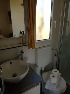 a bathroom with a sink and a toilet and a window at Relax Mobile Home, Terra Park SpiritoS in Kolan +32 photos