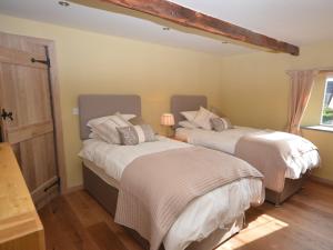 two beds in a room with a window at 2 Bed in Croyde GCOWS in Marwood