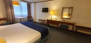 Postel nebo postele na pokoji v ubytování Hotel Bristol