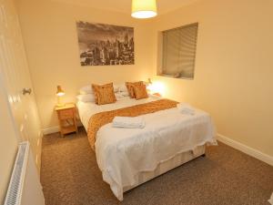 a bedroom with two beds and a window at The Squirrels in Hebden Bridge