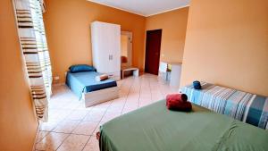 a bedroom with two beds and a room with at La Casa Del Viale in Solarino