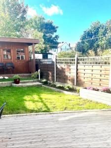 a fence in the backyard of a house at Gorgeous One Bedroom Apartment with Jacuzzi bath in Hither Green