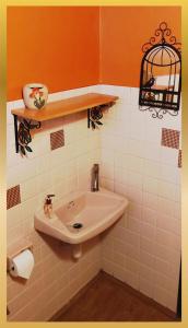 a bathroom with a sink and a bird cage on the wall at Sweetheart Tree Homestay in Bangkok