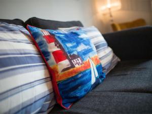 a pillow with a ship on it sitting on a couch at 1 Bed in Harrogate HH080 in Harrogate