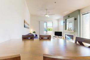 a living room with a large dining room table at Mariners Cove 150 in Santa Cruz