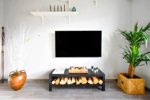 a black shelf with bread and a tv on a wall at 1bd Presidential Neighbor Retreat, Ac, Kitchen in Sofia
