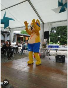 a person in a tiger mascot standing on a dance floor at Mobil home 5 pers proche d'Europa Park E020 in Boofzheim