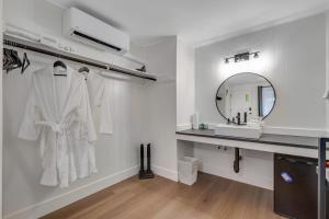 a bathroom with a white robe hanging on a wall at Mount Washington Room 2 at Mount Walker Inn in Quilcene