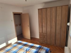 a bedroom with a bed and a closet at Temple saint sava in Dušanovac (historical) +8 photos