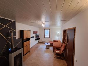 a living room with a couch and a kitchen at Marysieńka in Kwatoniów