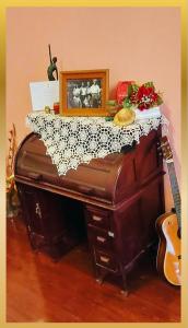 an old piano with a picture on top of it at Sweetheart Tree Homestay in Bangkok