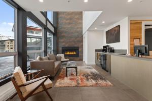 a living room with a couch and a fireplace at Enclave 207, Snowmass Ski-In/Ski-Out Condo w/Shared Pool/Hot Tub in Snowmass Village