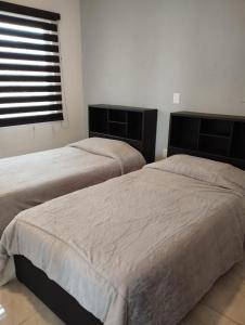 Ліжко або ліжка в номері Fabuloso Departamento en Teziutlán, Puebla