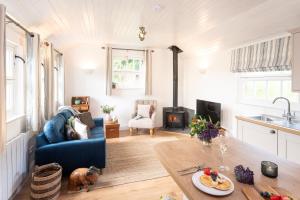 a living room with a blue couch and a table at Piglets Retreat in Budleigh Salterton