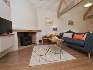 a living room with a couch and a table at 3 Bed in Sherborne COWOB in Haselbury Bryan