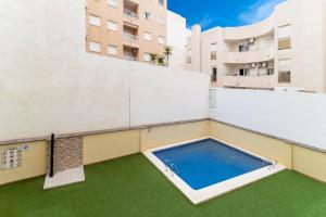 a swimming pool on the roof of a building at RELAX in Torrevieja