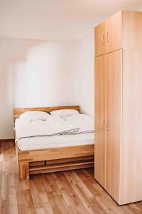 - une chambre avec un lit et une armoire en bois dans l'établissement 7/504, à Goslar