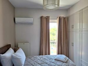 a bedroom with a bed and a window at Two Brothers Apartments Tsilivi in Planos +33 photos