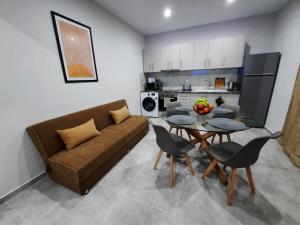 a living room with a couch and a table at Two Brothers Apartments Tsilivi in Planos