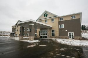 a building with a parking lot in front of it at GrandStay Hotel & Suites in Cannon Falls