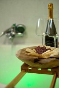 a plate of food on a table with a wine glass at Darrere del port in Alghero