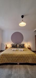 a bedroom with a large bed with a large ceiling at Casa Bonabal- 15 min from Ericeira 