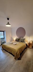 a bedroom with a large bed with a large headboard at Casa Bonabal- 15 min from Ericeira 