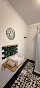 a bathroom with a sink and a mirror at Casa Bonabal- 15 min from Ericeira 