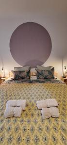 a bedroom with a large bed with two towels on it at Casa Bonabal- 15 min from Ericeira 