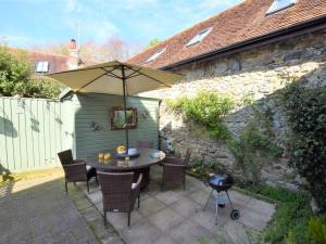 a patio with an umbrella and a table and chairs at 2 bed property in Shanklin Isle of Wight IC059 in Shanklin