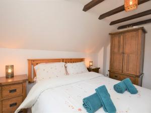 a bedroom with a white bed with blue towels on it at 2 bed property in Shanklin Isle of Wight IC059 in Shanklin