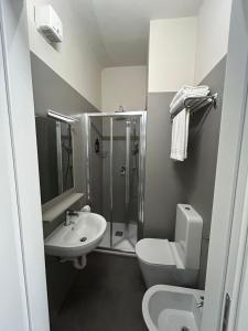 a bathroom with a toilet sink and a shower at Hotel 22 Marzo in Milan