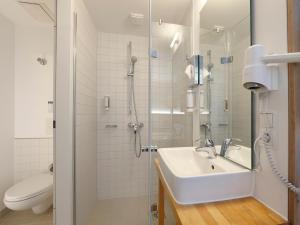 a bathroom with a sink and a shower at B&B HOTEL Berlin-Mitte in Berlin