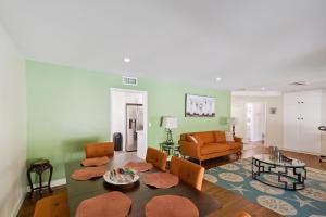 a living room with a couch and a table at Modern Relaxing Retreat with Private Pool home in Azusa