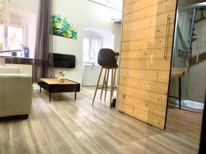 a living room with a wooden wall at K&H Apartman in Jihlava