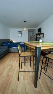 a living room with a table and chairs and a couch at Studio entier in Porrentruy