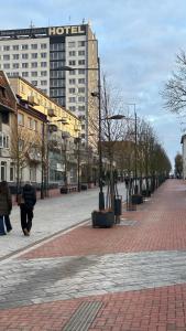 a city street with a hotel in the background at Central Boulevard Apartment 2 in Šiauliai