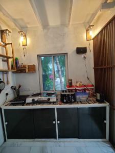 a kitchen with a counter top and a window at Private Villa by Rashuthere in Rasdhoo