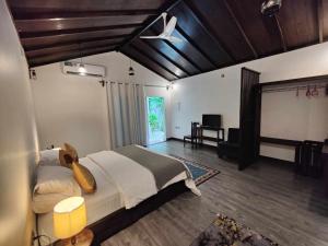 a bedroom with a large bed in a room at Private Villa by Rashuthere in Rasdhoo